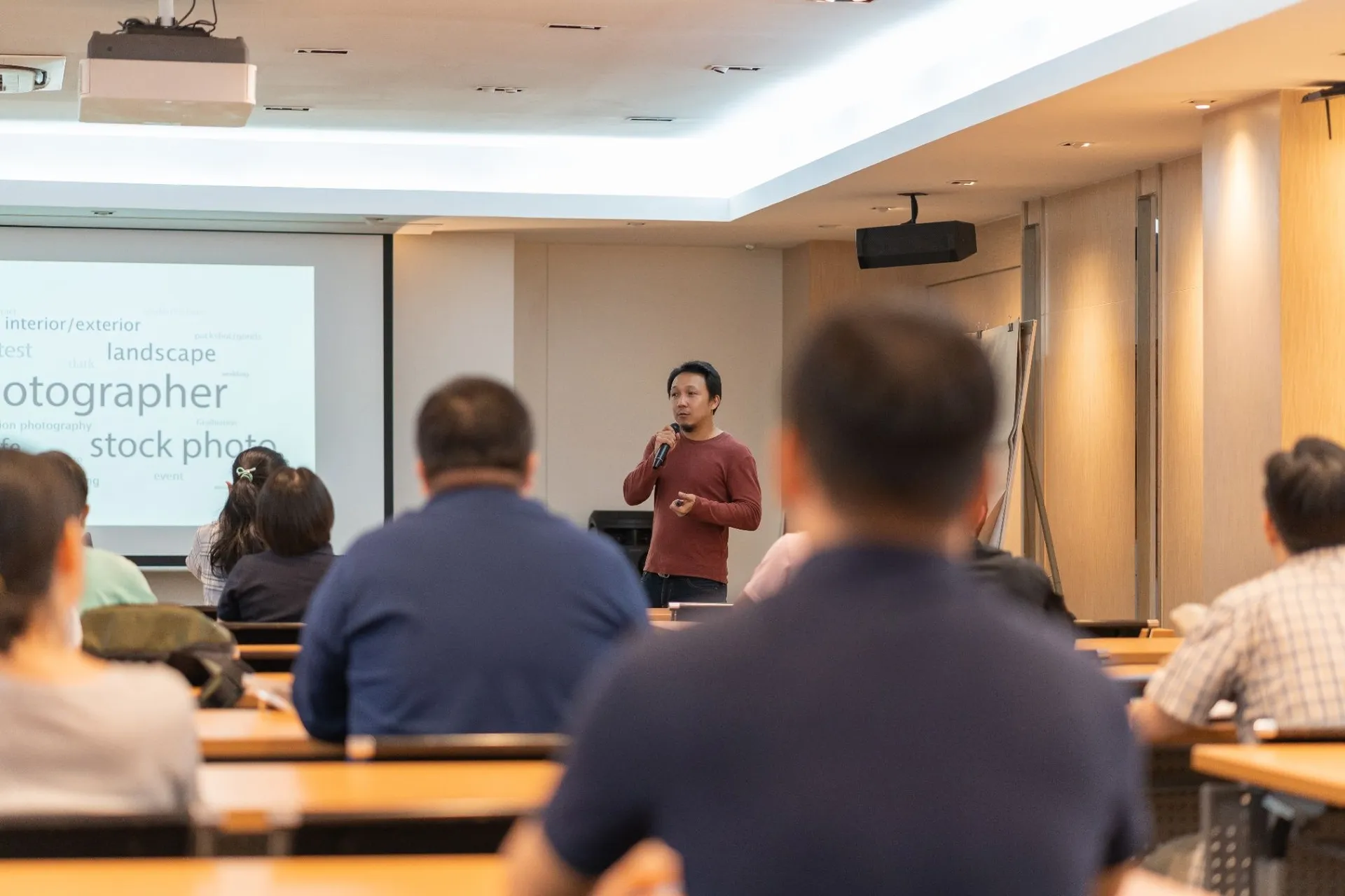 A small-business trainer speaking to an audience during a workshop