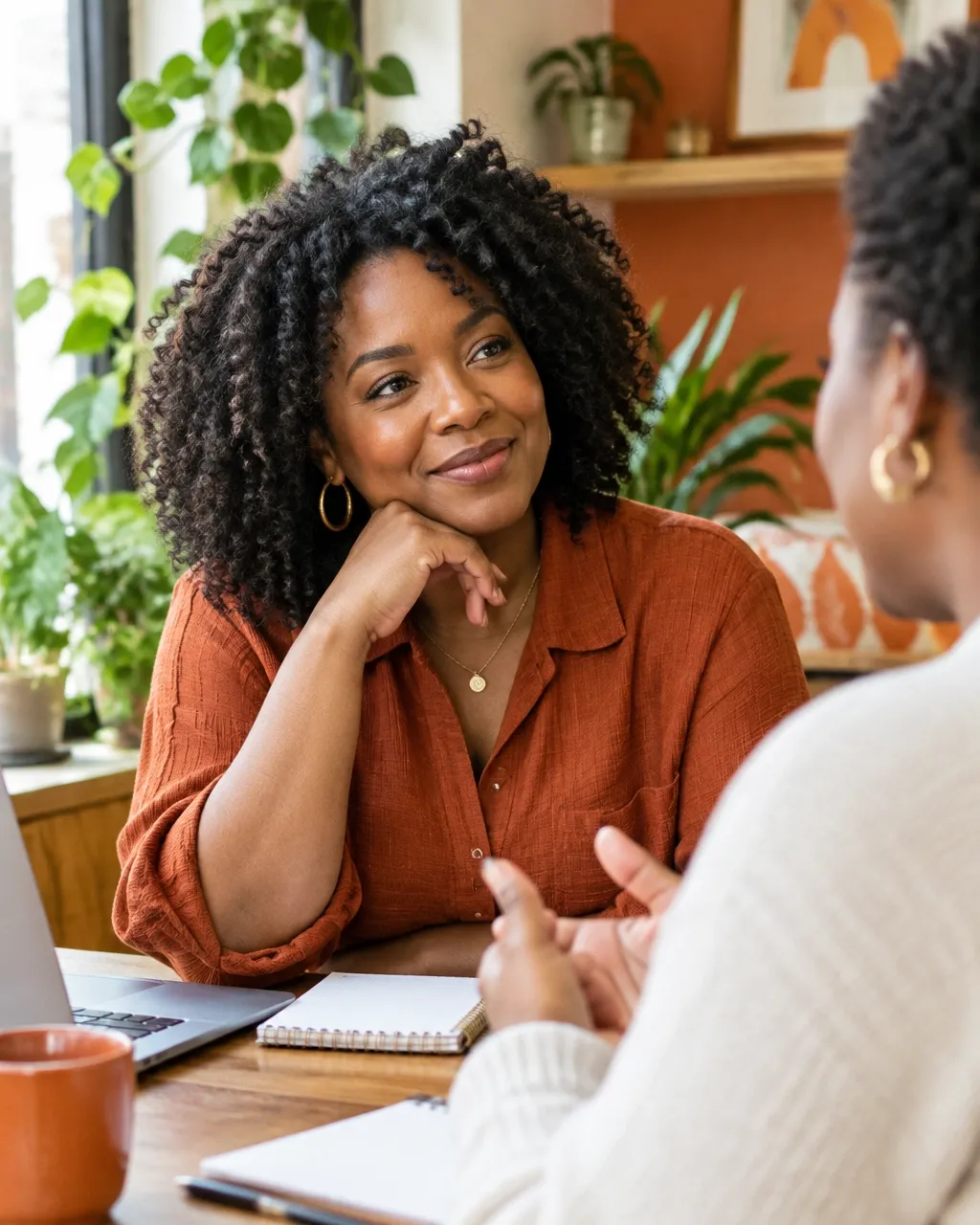 A Black woman small-business owner sharing a conversation with a colleague